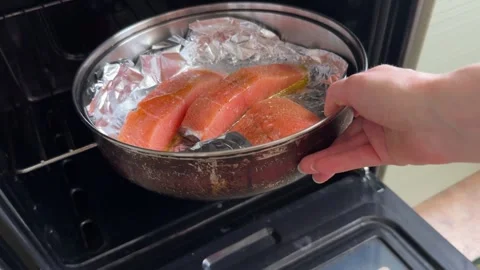 Pan with salmon is placed in the oven Stock-Footage 311236122