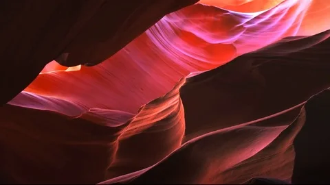 Pan of the sandstone rock wall in upper antelope canyon, az Video stock 75660431