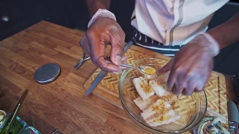 Pan seared cod fish preparation by Caribbean chef Stock Footage 267008147