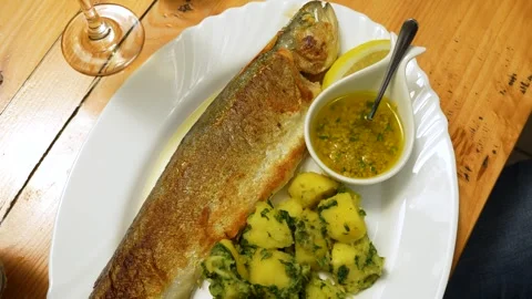 Pan-Seared Fresh River Trout Served with Herb Sauce and Potatoes. Stock Footage 341426802