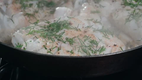 Pan searing fresh cod fillets with dill Stock Footage 330203596
