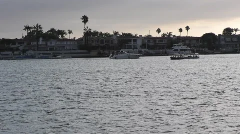 Pan of setting sun under cloudy sky with multiple boats moving about.mp4 Stock Footage 67466041