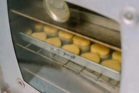 A pan of several Eid cakes is ready to go into the oven to be cooked. Stock Photos