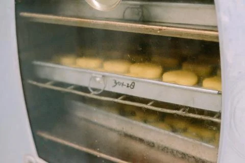 A pan of several Eid cakes is ready to go into the oven to be cooked. Stock Photos