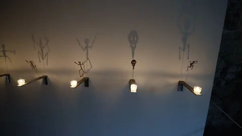 Pan of shadow arts and candles to family in basement Stock Footage 121753829