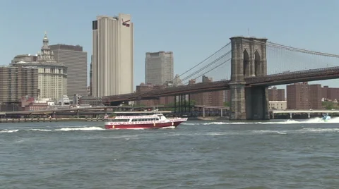 Pan ships under Brooklyn Bridge Stock Footage 40140969