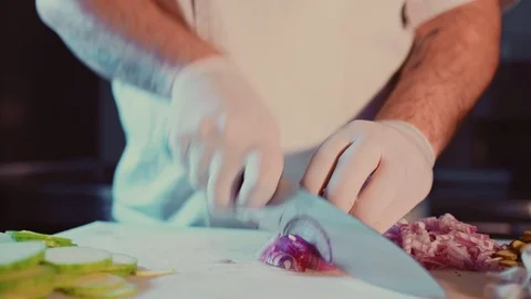 Pan shoot of a cook cutting onion in the kitchen 스톡 동영상 104197809