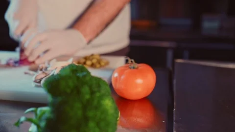 Pan shoot of kitchen chef cutting onion on the cutting board Stock Footage 104196471