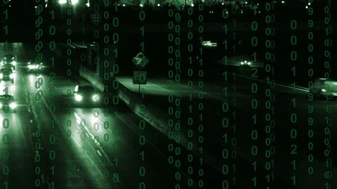 Pan shot across a busy freeway at night with binary computer code Vidéo 102928405