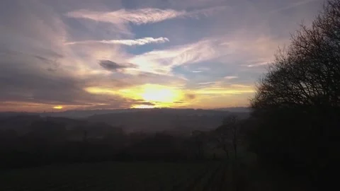 Pan Shot across a Picturesque Countryside with the Sun Setting Stock Footage