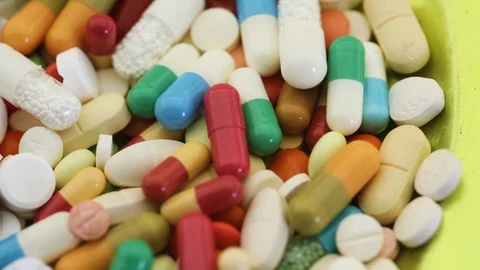 Pan shot across pile of different medication pills Stock Footage 95913270