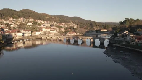 A pan shot of a beautiful river surrounded by houses on the steps of hill Stock Footage 219025011