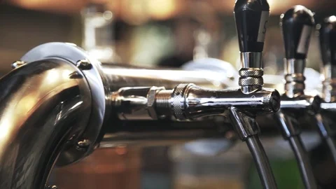 Pan shot of beer taps in a bar Stock Footage