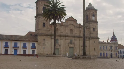 Pan Shot of Bell Tower in Columbia with Birds and People  Stock Footage 120580996