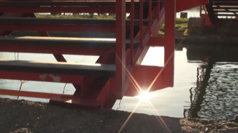 Pan Shot Of A Bridge Over The Water With Sun flare Stock Footage 34011574