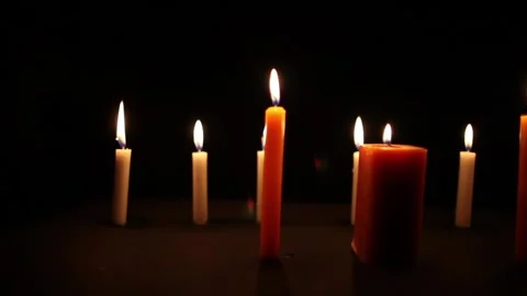 Pan shot of candles burning in the darkness Stock Footage 243628615