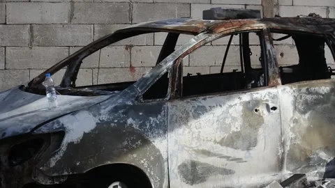 Pan Shot of a car caught on fire as a result of an exploding fuel oil Stock Footage 248053618