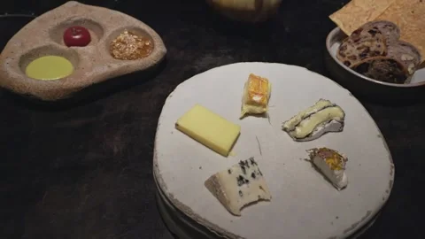 Pan shot of Cheese Platter with Condiments and Bread Stock Footage 314346996