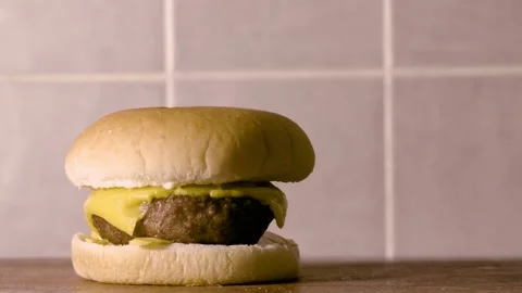 Pan shot of a cheeseburger Stock Footage 132036908