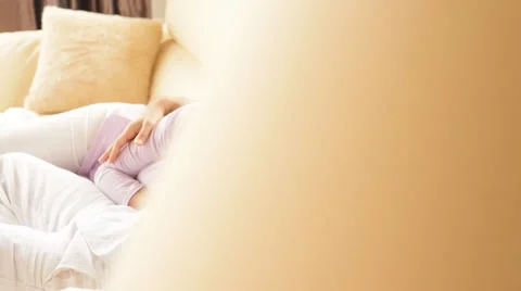 Pan shot of couple lying on Sofa Stock Footage 43607257