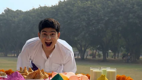 Pan shot of a cute Indian guy is really excited to celebrate the joyful Holi ... Stock Footage 124520372