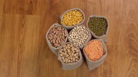 Pan shot of different Dals / lentils kept on a wooden table for preparing a t... Stock Footage 162291357
