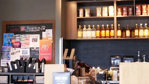 Pan shot of display full of coffee inside Starbucks store with 4k resolution. Stock Footage 83763527