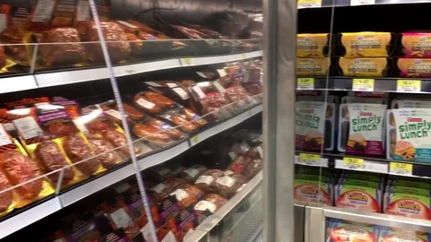 Pan shot of display meat and hot dog for sale inside Walmart store Stock Footage 72096523