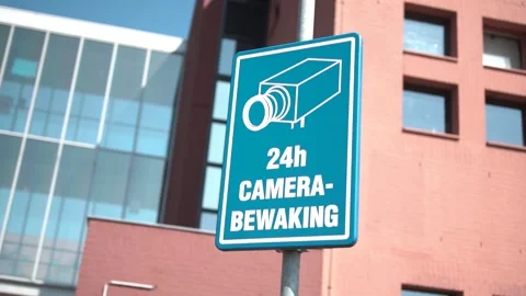 Pan Shot Of A Dutch Camera Security Sign At ASchool Stock Footage 130676753