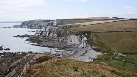 Pan shot of an empty field and cliffs Stock Footage 115417030