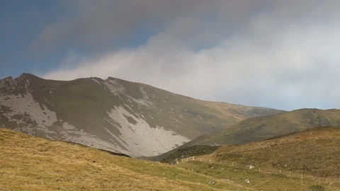 Pan shot of field, with views of small mountains Stock Footage 115740011