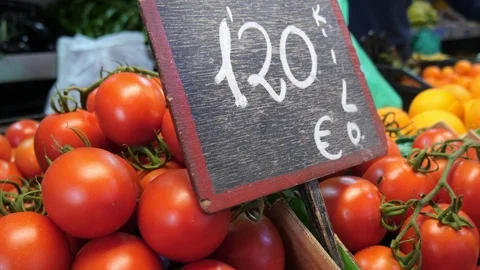 Pan shot of grape tomatoes and a black board with the price Stock Footage 124462343