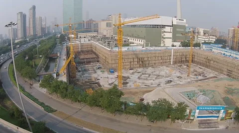 Pan shot of a huge construction site and vehicles driving through a bridge 動画素材 42410096
