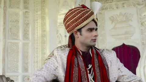 Pan shot of a Indian groom posing in traditional wedding dress Stock Footage 30097124