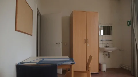 Pan Shot Inside A Room With A Table, Chairs, Closet, Sink And Cupboard Stock Footage 126700532