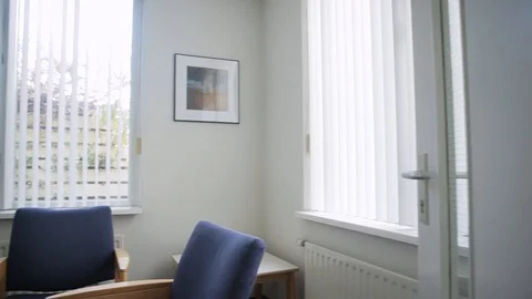 Pan Shot Inside A Small Talking Room With Blue Chairs And Other Furniture Stock Footage 126700536