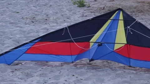 Pan Shot of Kite Lying on Sand Stock Footage 51346397