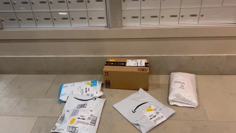 Pan shot of the lockboxes place full of parcels on the floor. Stock Footage 243250226