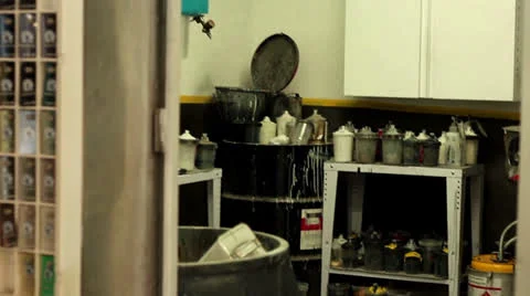 Pan shot looking into auto body shop paint supply room Video stock 25879017