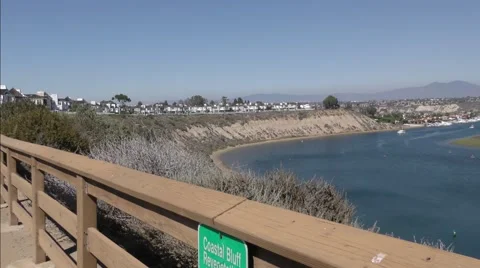 Pan shot of lower bay with saddle back mountains and fashion island  Stock Footage 67555419