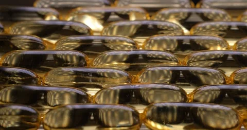 Pan shot, macro view: Vitamins supplements pills omega 3. Fish oil capsules. 4k Stockbeeldmateriaal 108102365