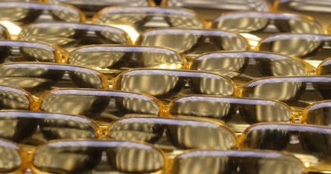 Pan shot, macro view: Vitamins supplements pills omega 3. Fish oil capsules. 4k Stockbeeldmateriaal 108102663