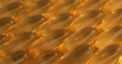 Pan shot, macro view: Vitamins supplements pills omega 3. Fish oil capsules. 4k Stockbeeldmateriaal 108104065