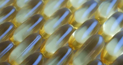 Pan shot, macro view: Vitamins supplements pills omega 3. Fish oil capsules. 4k Stockbeeldmateriaal 108104083