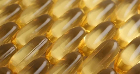 Pan shot, macro view: Vitamins supplements pills omega 3. Fish oil capsules. 4k Stockbeeldmateriaal 108104253