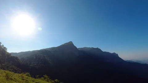 Pan shot of a mesmerizing landscape in a forest on a bright morning, India Видео 119314026