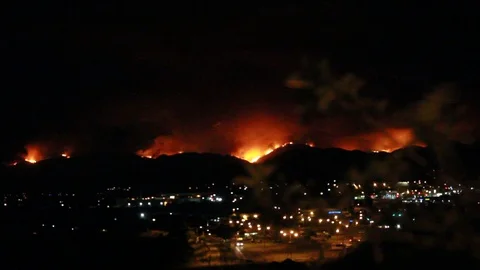 Pan shot from the moon to a fire behind a city Stock Footage 109207047