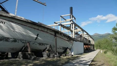 Pan Shot of Old Gold Rush Paddlewheel Steam Boat Along River Canada Stock Footage 80725455