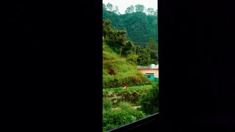 Pan Up Shot of Open Window Revealing Green Mountain Landscape  Ultra HD 4K Stock Footage 339851599