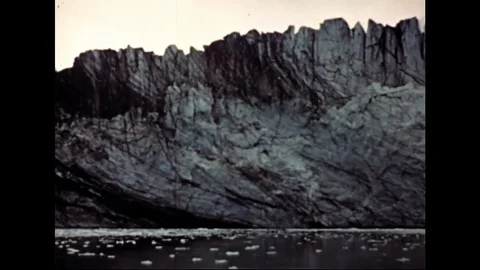Pan Shot Over Glacier By The Coast With Falling Ice Into Sea Stock Footage 104882306